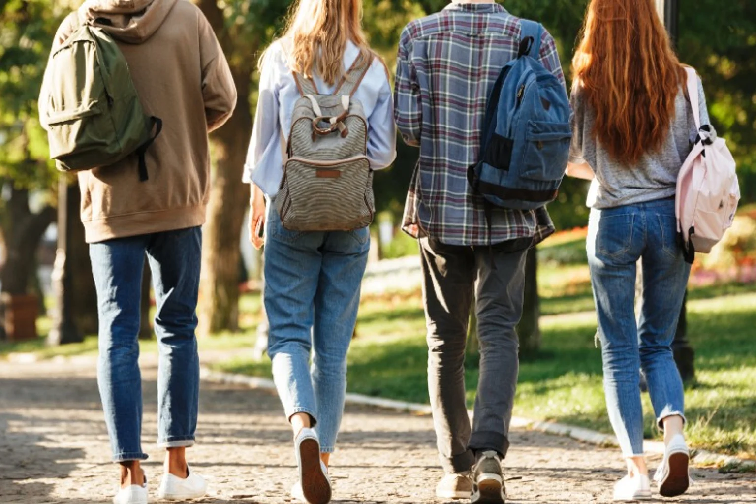 College students walking on a campus path with backpacks